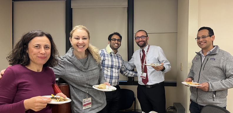 Faculty enjoy food at D&I potluck. 